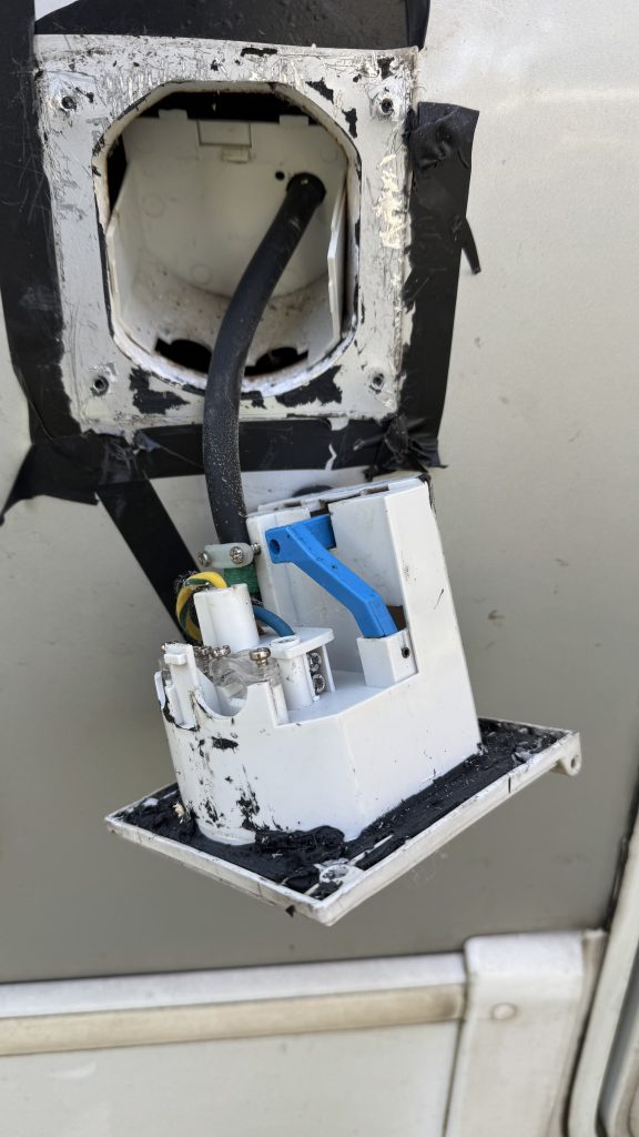 Broken electrical socket on the side of a motorhome