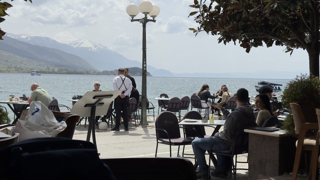 Lakeside cafe with people sat out by the water on the terrace
